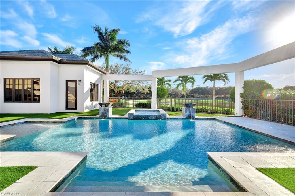 16988 Fairgrove Way Naples, FL 34110 - Photo 33 of 34 swimming pool view with a garden space