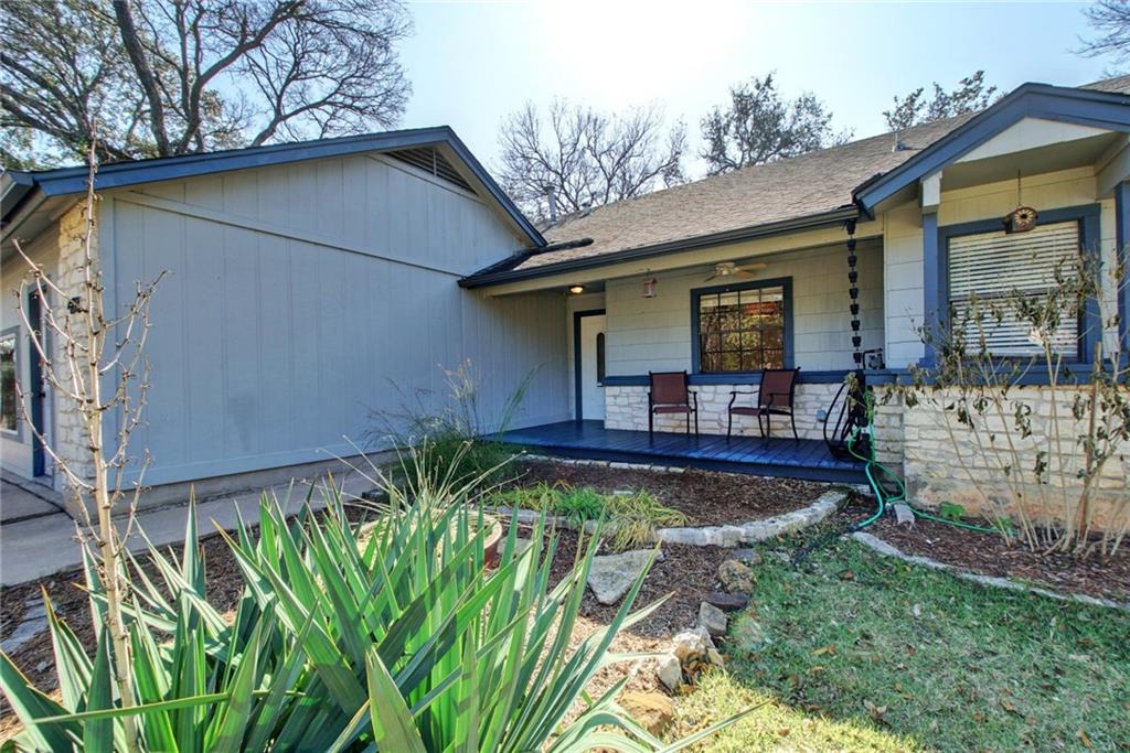 a view of a house with backyard and sitting area