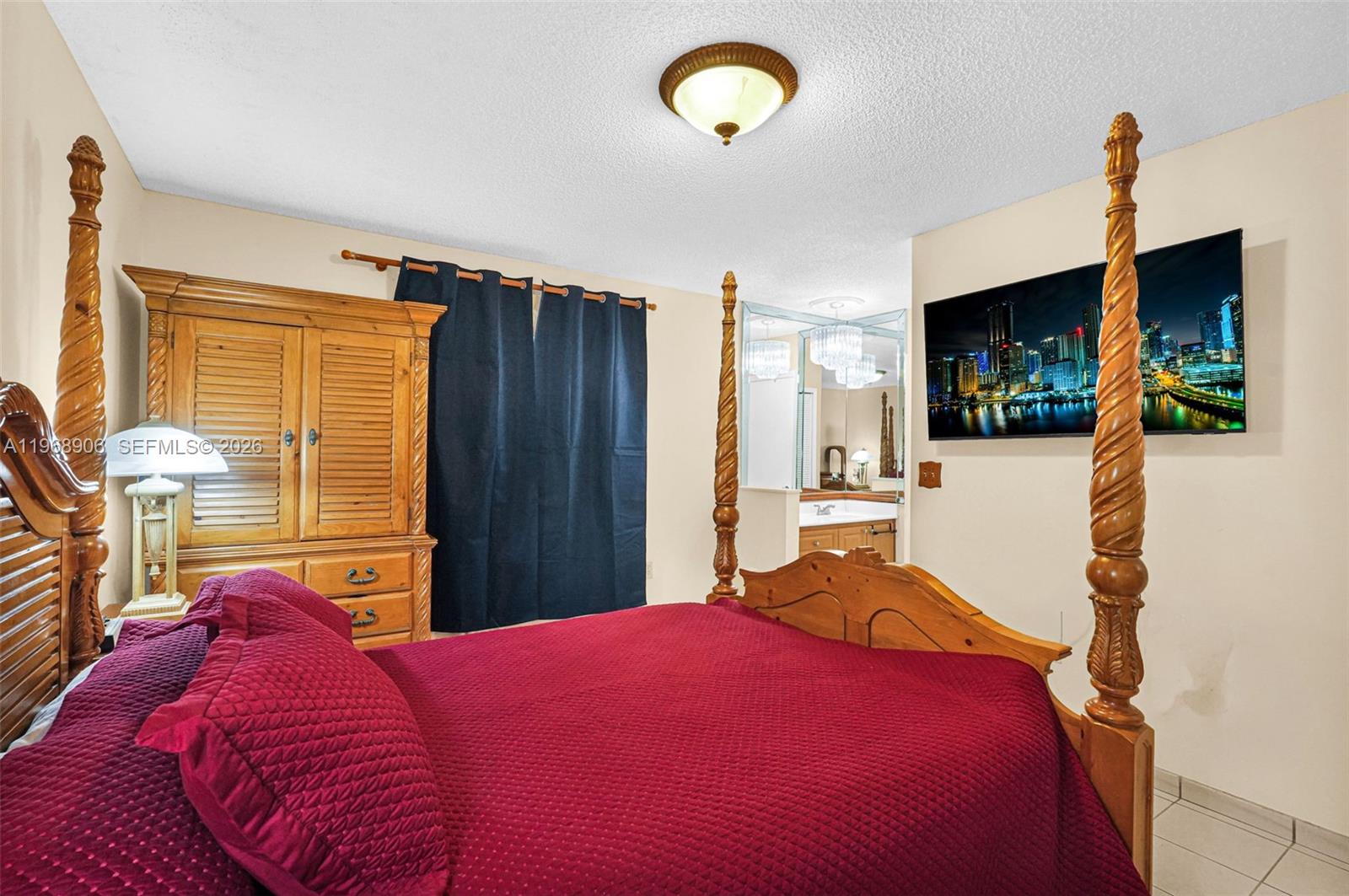 3289 West 70th Street Hialeah, FL 33018 - Photo 17 of 50 a bedroom with a bed and a chandelier