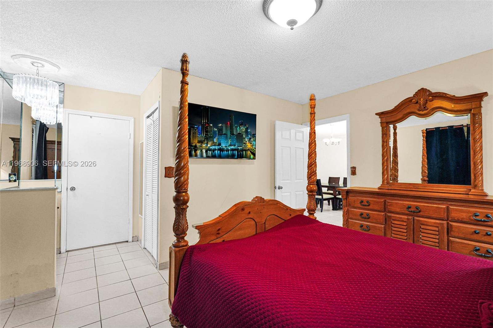 3289 West 70th Street Hialeah, FL 33018 - Photo 18 of 50 a bedroom with a bed a dresser and flat screen tv