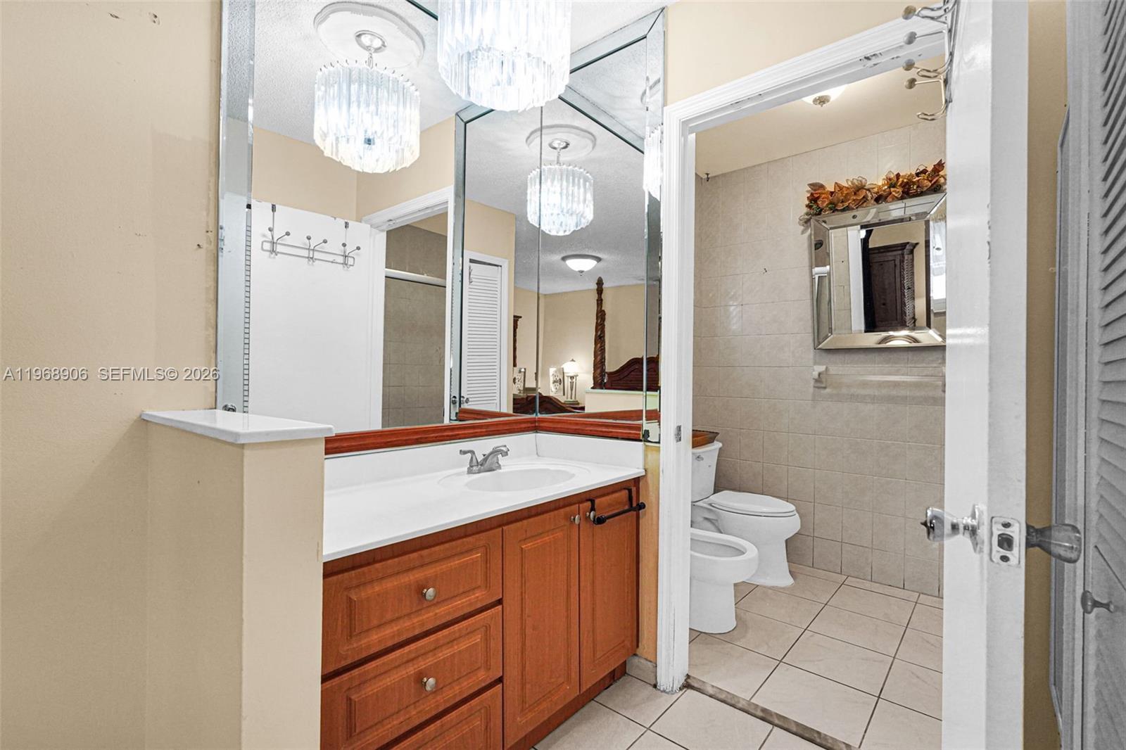 3289 West 70th Street Hialeah, FL 33018 - Photo 19 of 50 a spacious bathroom with a granite countertop toilet sink and mirror