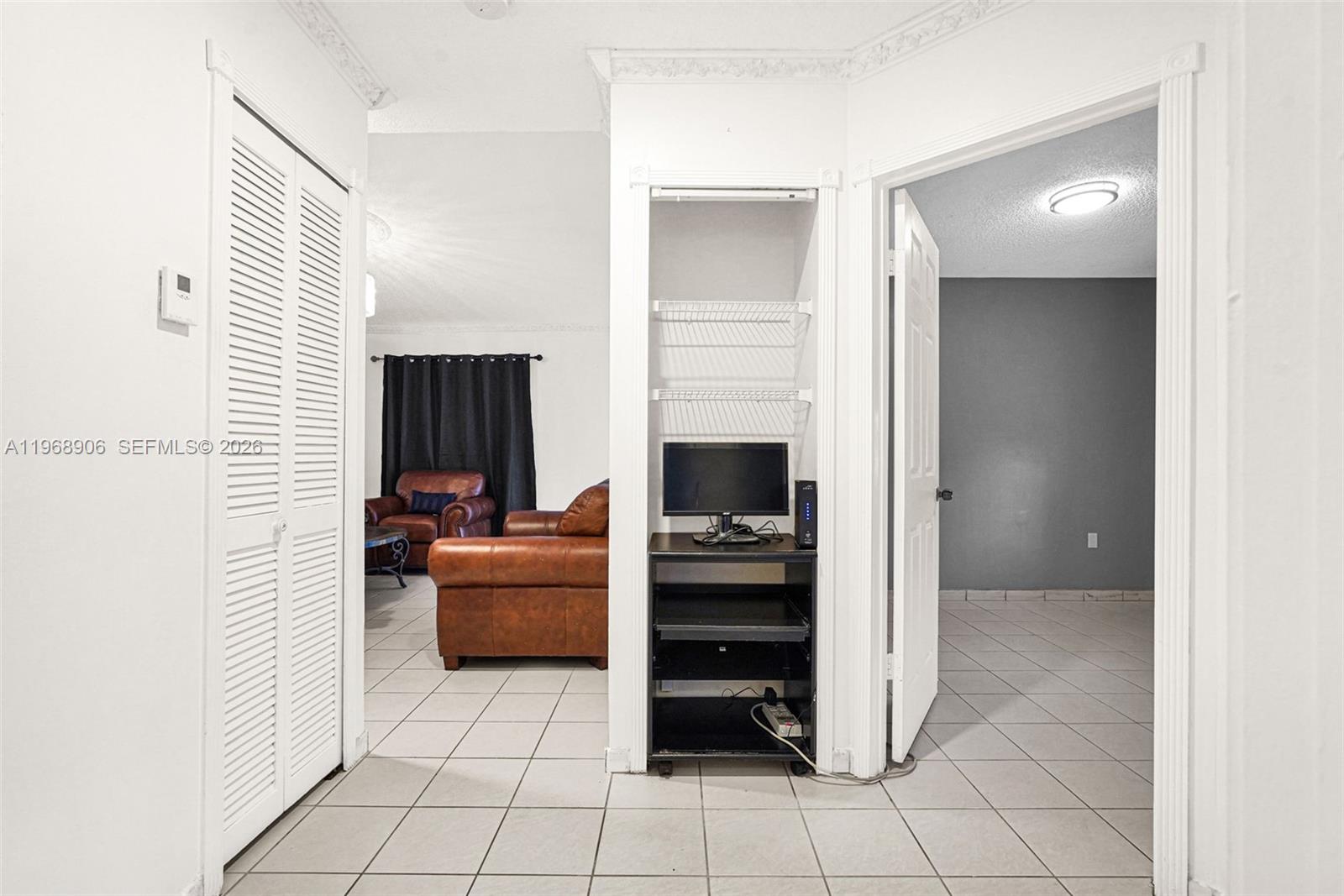 3289 West 70th Street Hialeah, FL 33018 - Photo 23 of 50 a living room with furniture and a flat screen tv