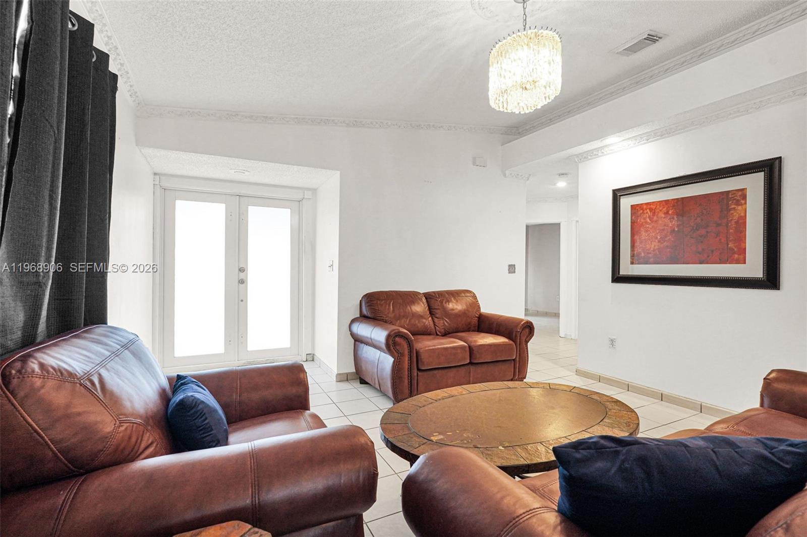 3289 West 70th Street Hialeah, FL 33018 - Photo 3 of 50 a living room with furniture and a large window