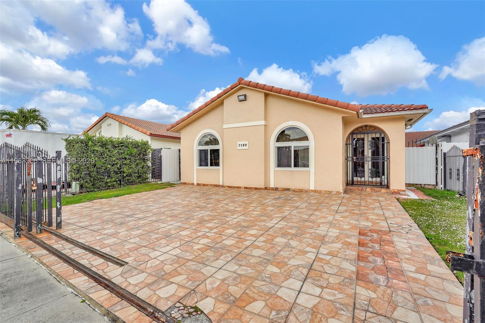3289 West 70th Street Hialeah, FL 33018 - Photo 46 of 50 a view of a white house with a yard