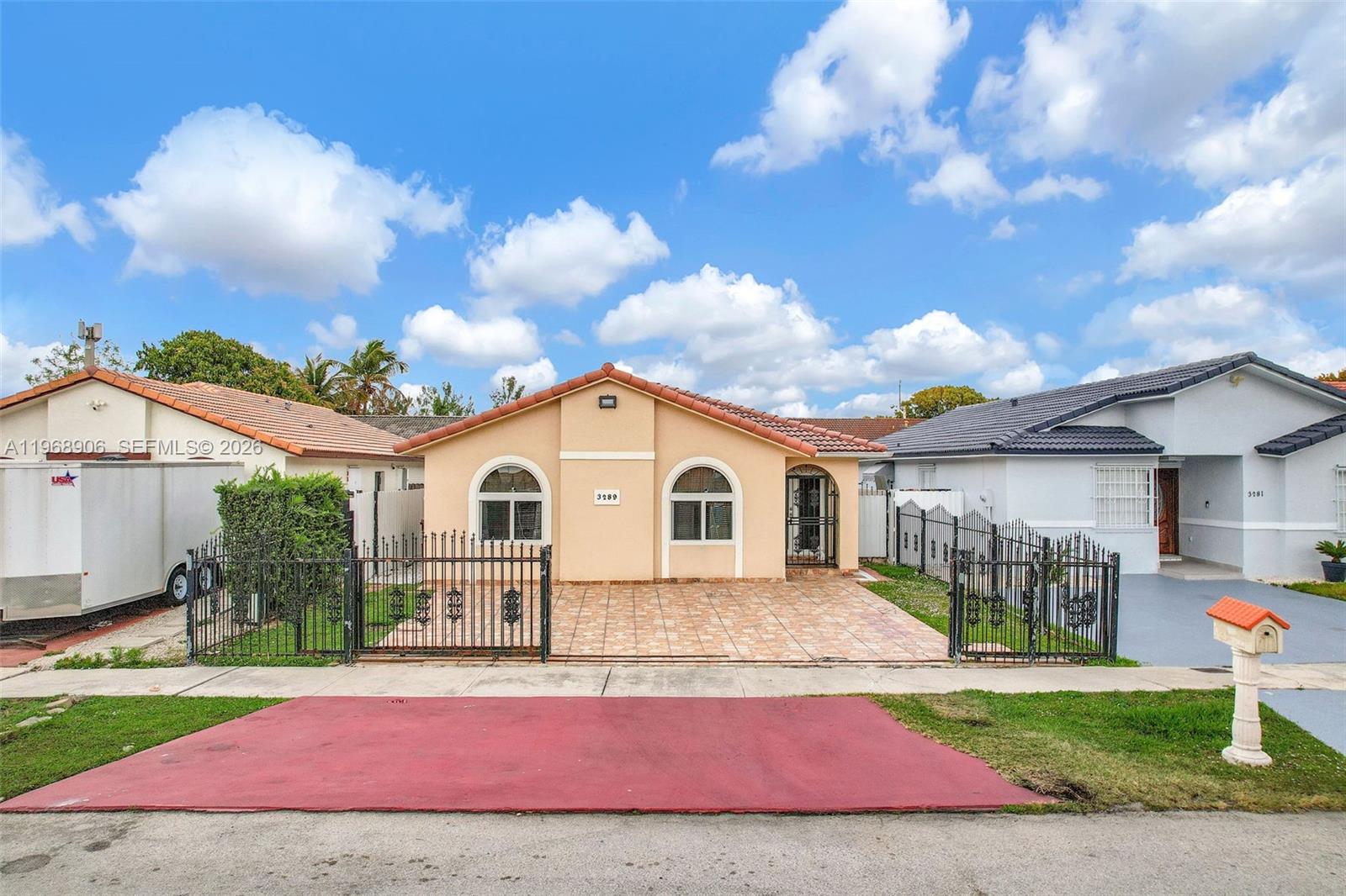 3289 West 70th Street Hialeah, FL 33018 - Photo 48 of 50 a front view of a house with a yard and garage