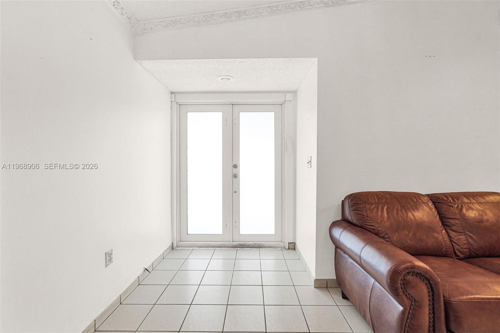 3289 West 70th Street Hialeah, FL 33018 - Photo 50 of 50 a living room with a couch and a rug