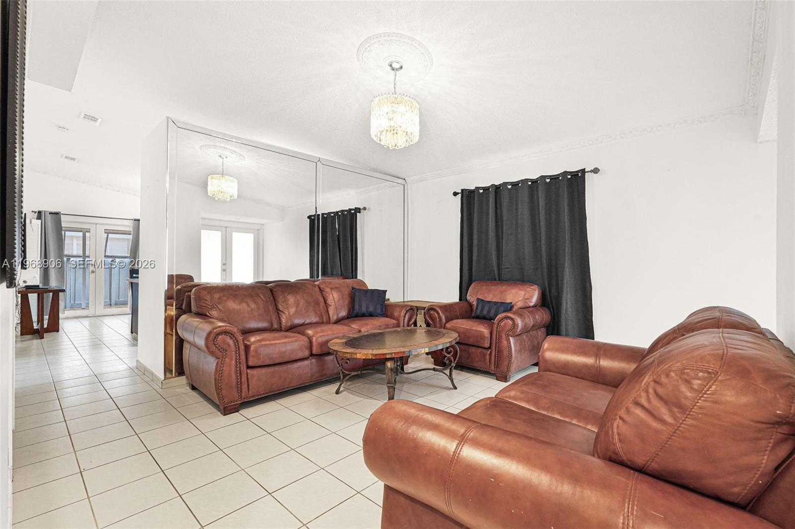 3289 West 70th Street Hialeah, FL 33018 - Photo 5 of 50 a living room with furniture a lamp and a chandelier
