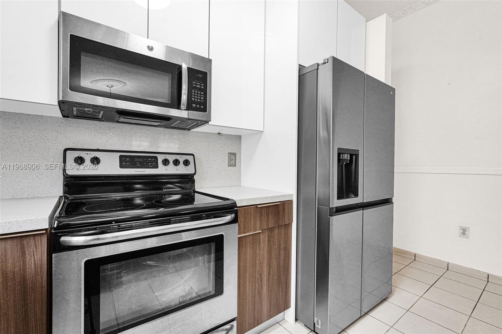 3289 West 70th Street Hialeah, FL 33018 - Photo 8 of 50 a kitchen with stainless steel appliances a stove microwave and sink