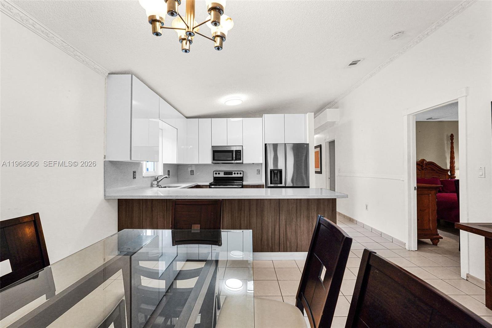 3289 West 70th Street Hialeah, FL 33018 - Photo 10 of 50 a view of a dining room with furniture and wooden floor
