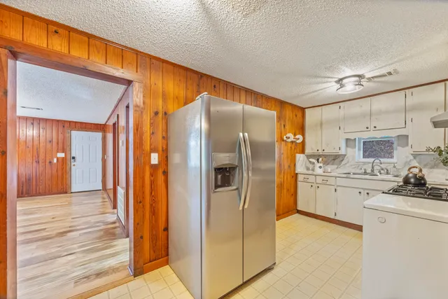 a kitchen with stainless steel appliances a refrigerator and a stove top oven
