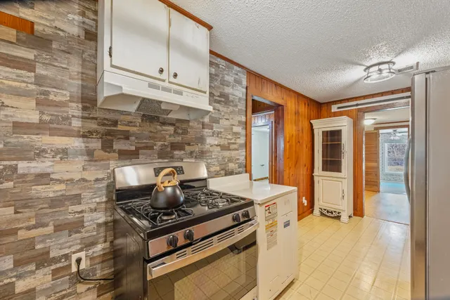 a kitchen with stainless steel appliances granite countertop a stove and a refrigerator