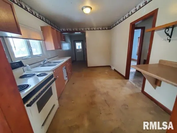 a kitchen with a stove and a refrigerator