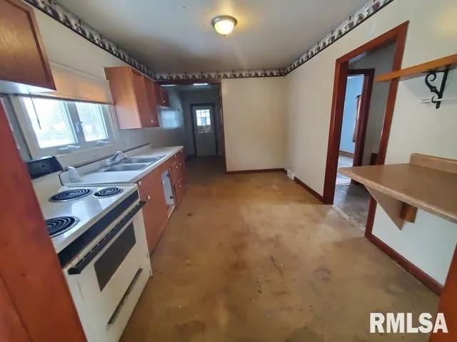 a kitchen with a stove and a refrigerator