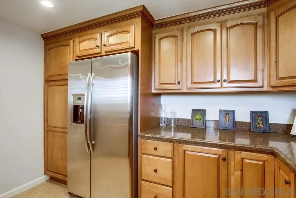 16632 Roca Drive San Diego, CA 92128 - Photo 17 of 44 a kitchen with stainless steel appliances granite countertop a refrigerator and cabinets