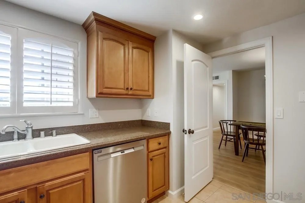 16632 Roca Drive San Diego, CA 92128 - Photo 18 of 44 a utility room with stainless steel appliances granite countertop a sink and a window