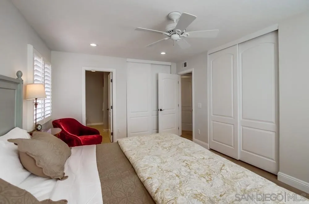 16632 Roca Drive San Diego, CA 92128 - Photo 21 of 44 a bedroom with a bed and a chandelier
