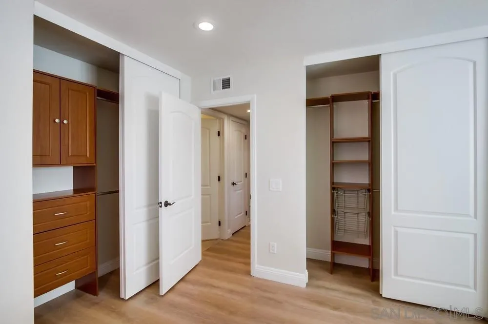 16632 Roca Drive San Diego, CA 92128 - Photo 25 of 44 an empty room with closet and wooden floor