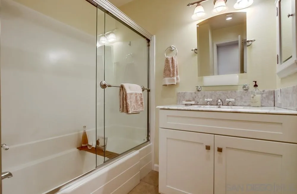 16632 Roca Drive San Diego, CA 92128 - Photo 30 of 44 a bathroom with a shower sink and mirror