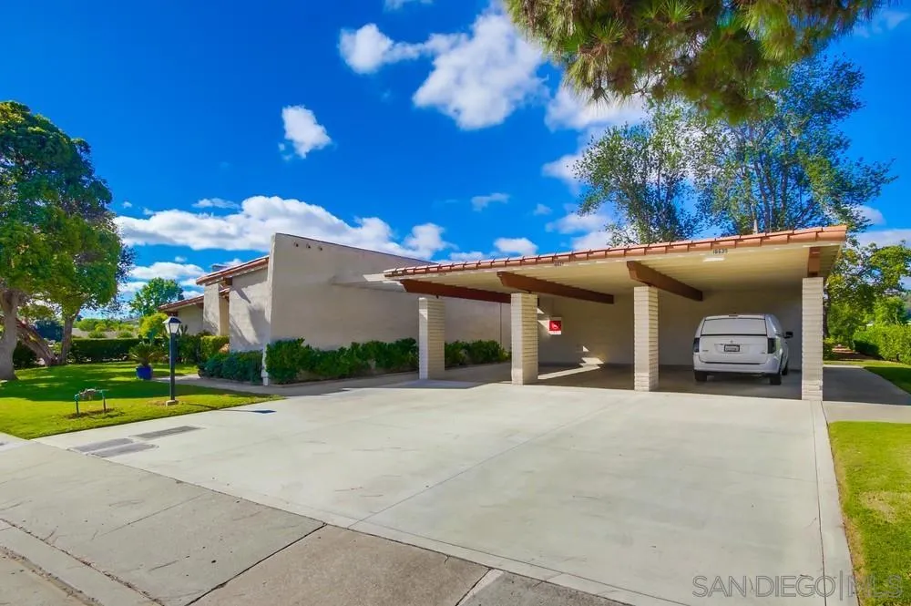 16632 Roca Drive San Diego, CA 92128 - Photo 42 of 44 a front view of a house with a yard and trees