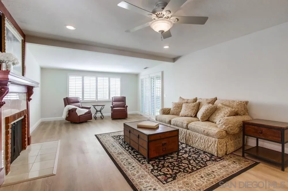 16632 Roca Drive San Diego, CA 92128 - Photo 6 of 44 a living room with furniture ceiling fan and a rug