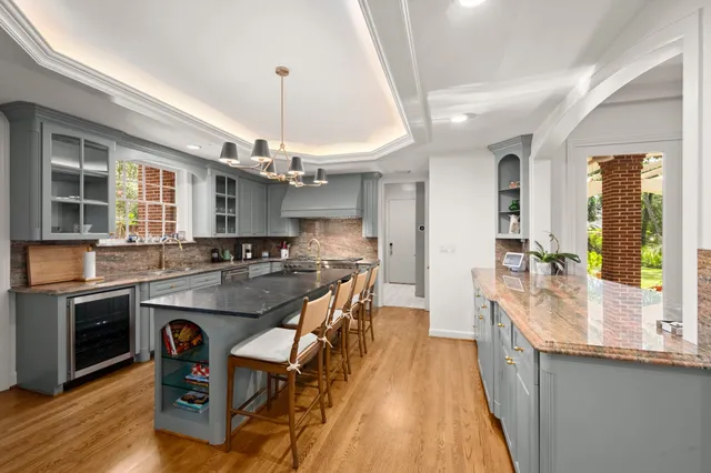 a kitchen with counter top space and wooden floor