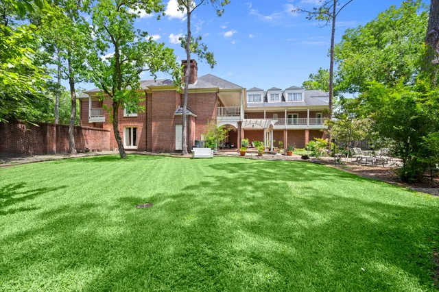 a front view of a house with a yard table and chairs