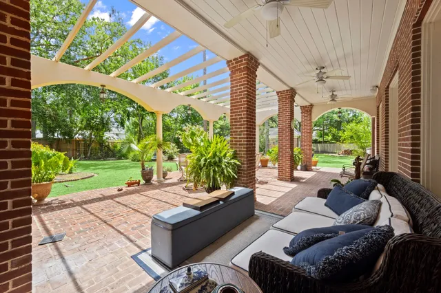 a living room with patio furniture and a garden