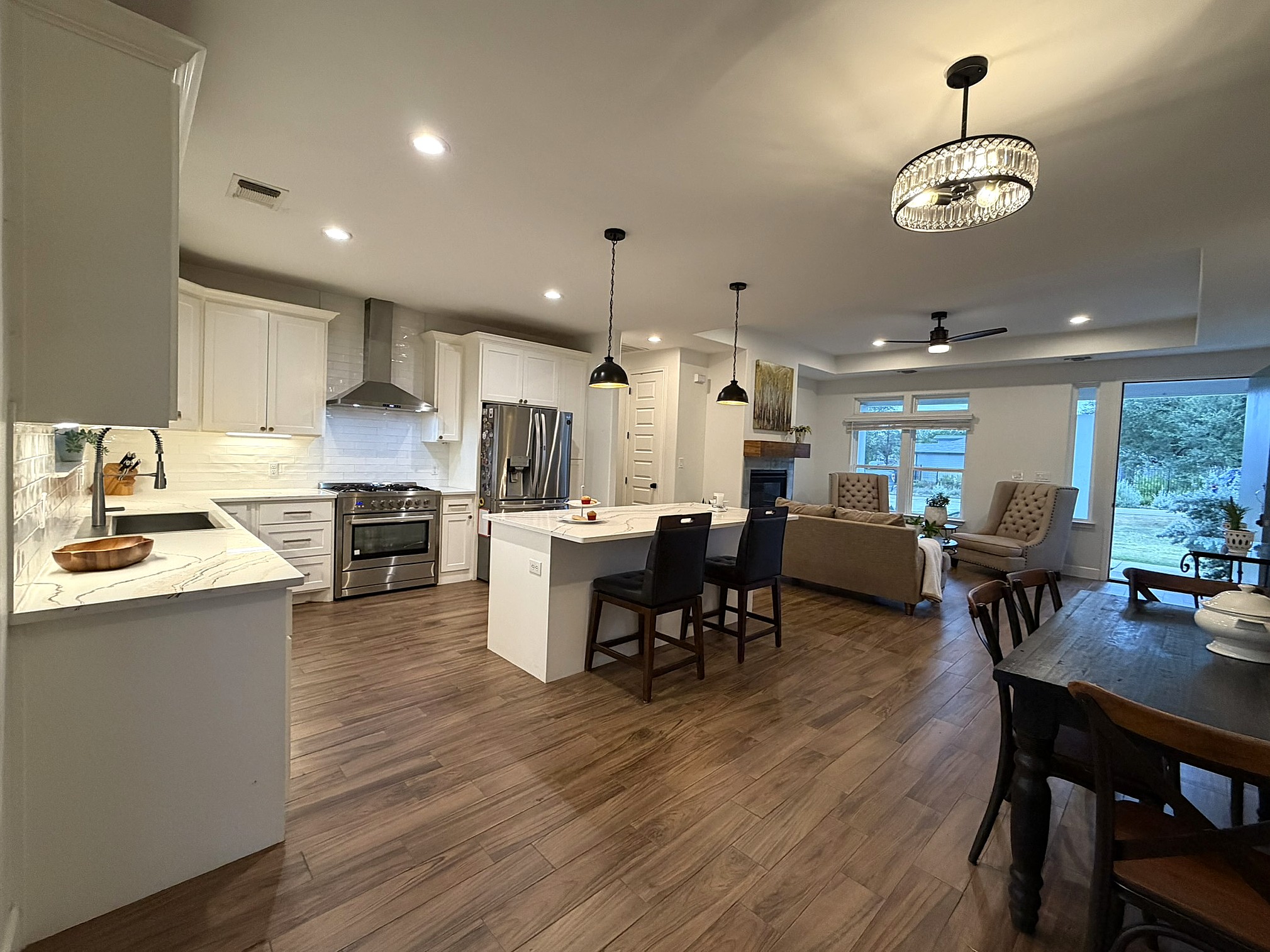20602 Oak Ridge Lago Vista, TX 78645 - Photo 8 of 35 Rich wood-look flooring connects this spacious culinary workspace directly to the living and dining areas.