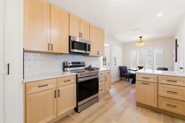 a kitchen with stainless steel appliances white cabinets and a sink