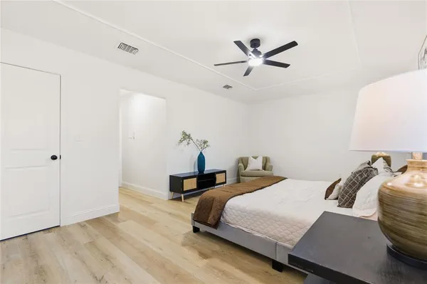 a bedroom with a bed and a ceiling fan