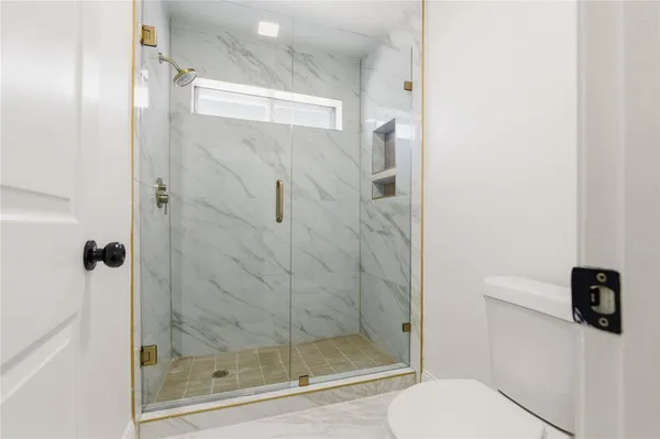 a bathroom with a shower and toilet