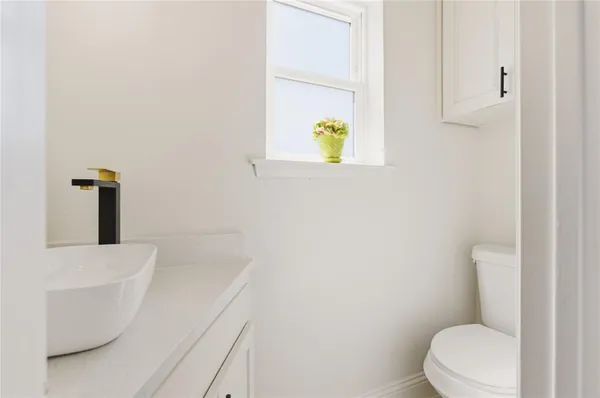 a white toilet sitting next to a white sink