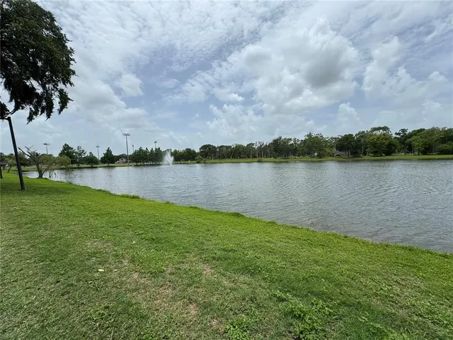a view of a lake with houses in the back