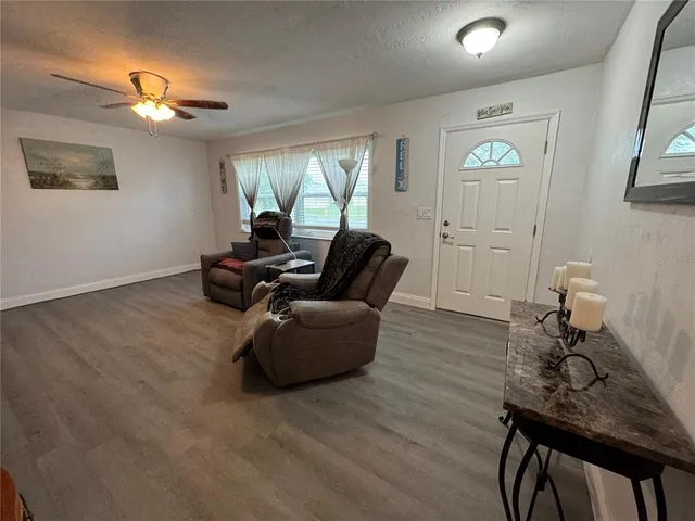 a living room with furniture and wooden floor
