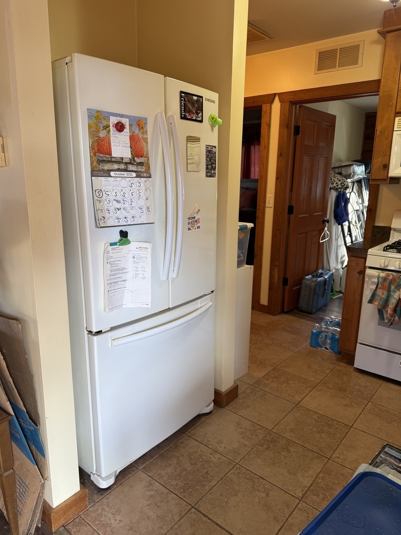 211 Walleye Circle Wilmington, IL 60481 - Photo 9 of 15 a white refrigerator freezer and a microwave in a kitchen