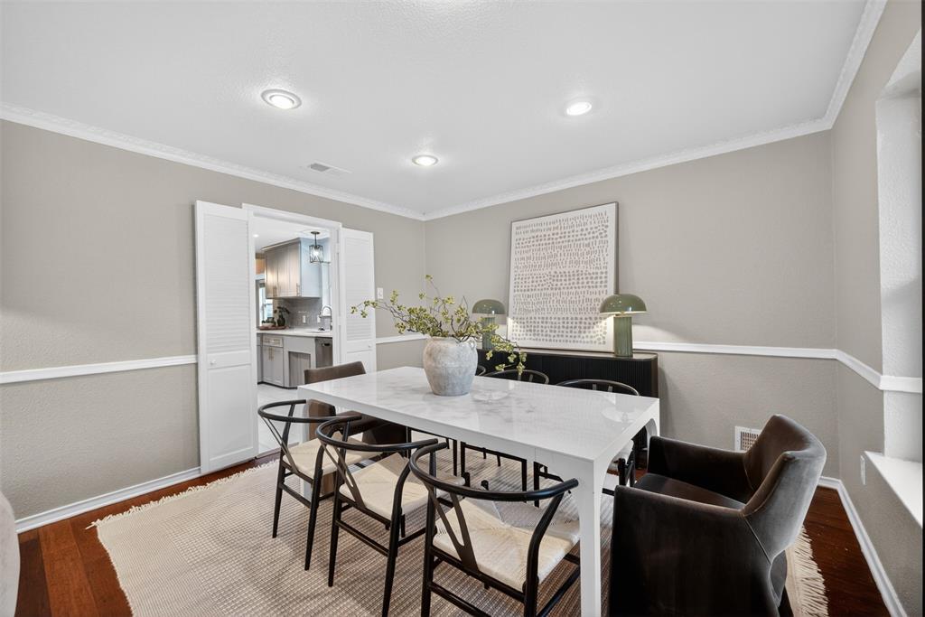 9660 Timberleaf Drive Dallas, TX 75243 - Photo 17 of 40 Recessed lighting illuminates a dining area featuring rich wood-finish flooring, white crown molding, and a white chair rail