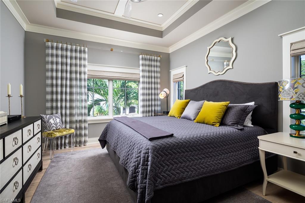 3170 Crayton Road Naples, FL 34103 - Photo 33 of 50 a bed sitting in a bedroom next to a window