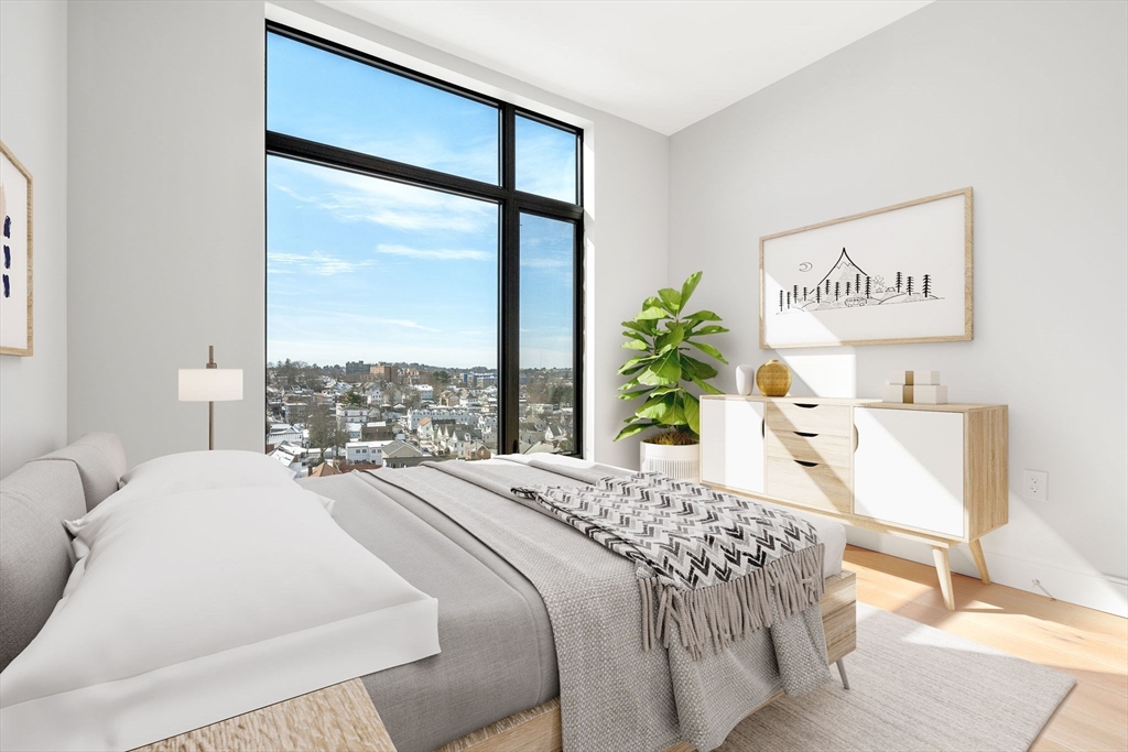 191 Washington Street, Unit 710 Boston, MA 02135 - Photo 13 of 35 a bedroom with a large bed and a large window