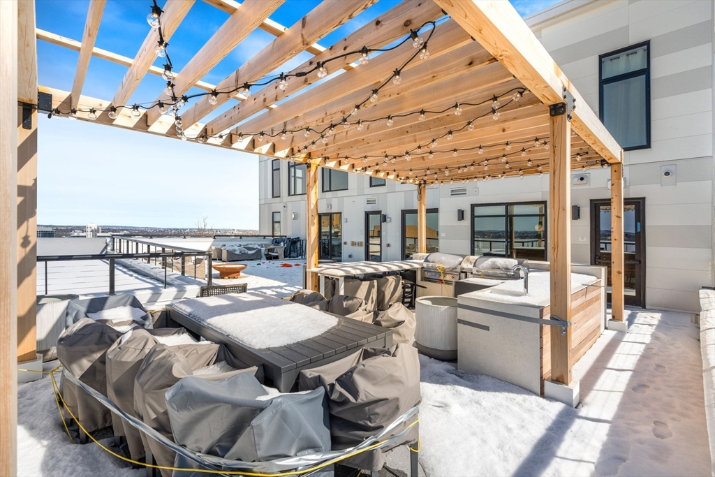 191 Washington Street, Unit 710 Boston, MA 02135 - Photo 21 of 35 a living room with furniture and a floor to ceiling window