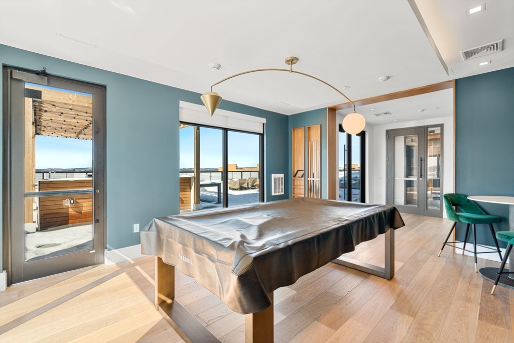 191 Washington Street, Unit 710 Boston, MA 02135 - Photo 22 of 35 a dining hall with stainless steel appliances granite countertop a stove and a sink