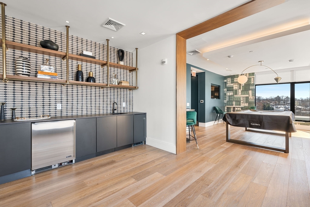 191 Washington Street, Unit 710 Boston, MA 02135 - Photo 24 of 35 a living room with a wooden floor