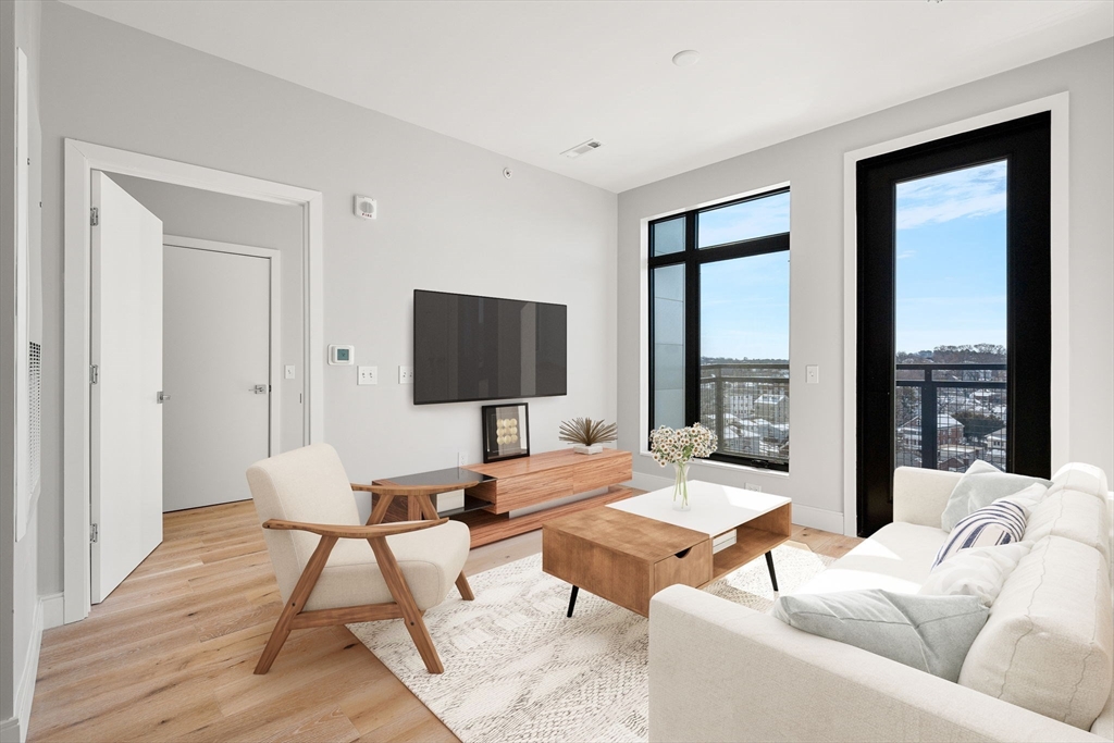 191 Washington Street, Unit 710 Boston, MA 02135 - Photo 3 of 35 a living room with furniture and a flat screen tv