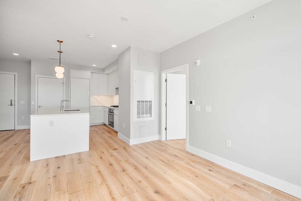 191 Washington Street, Unit 710 Boston, MA 02135 - Photo 8 of 35 a view of kitchen with wooden floor