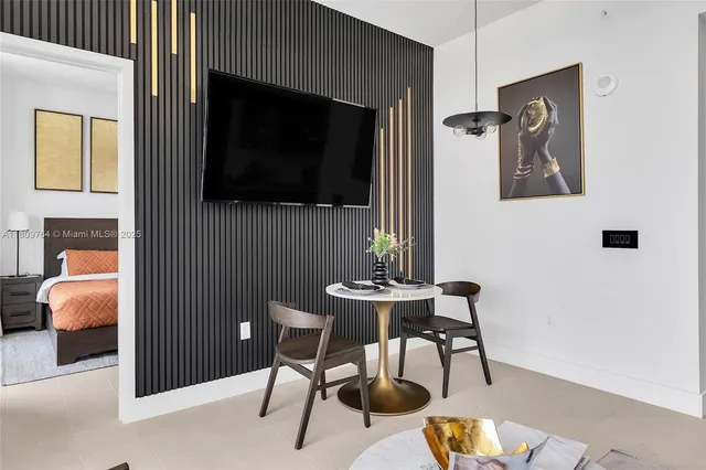 a work room with furniture and a flat screen tv