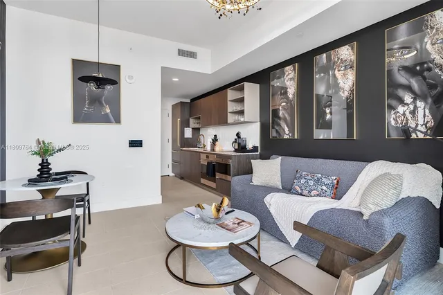 a living room with furniture and a floor to ceiling window
