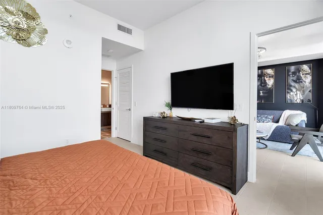 a bedroom with a large bed and a balcony view