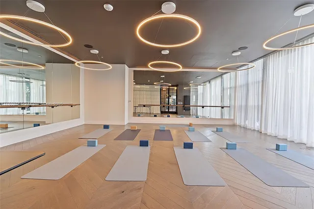 a living room with furniture and potted plants