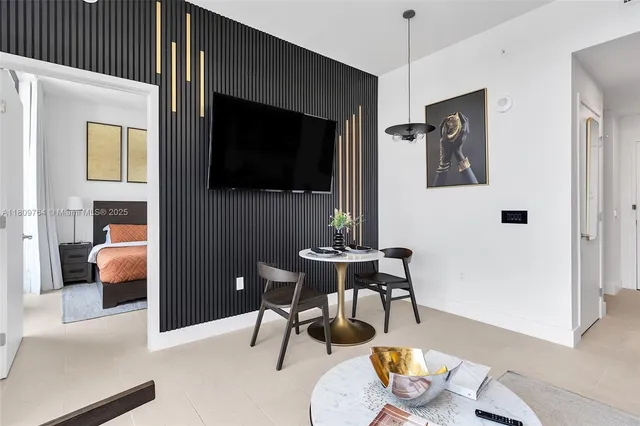 a view of a livingroom with furniture and a flat screen tv