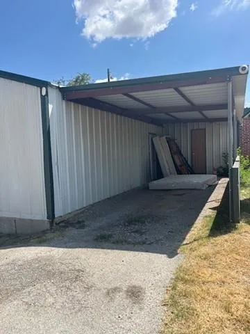 a view of small space in front of house