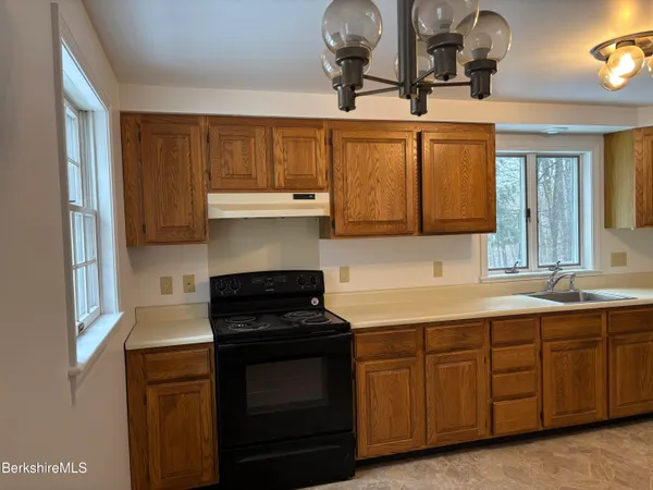 a kitchen with a sink cabinets and appliances